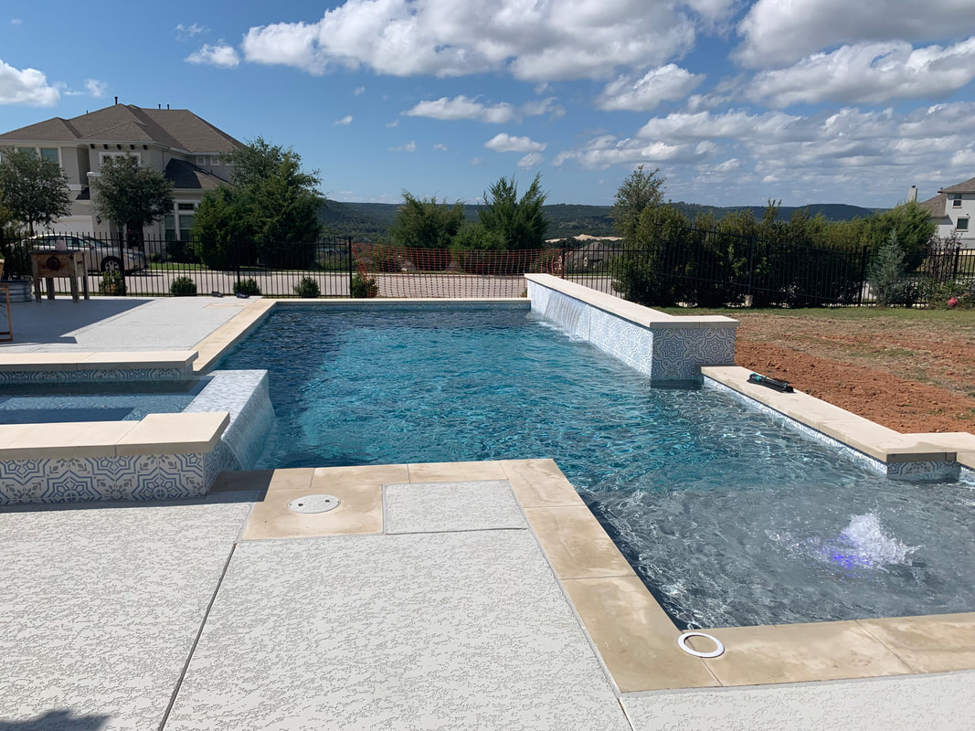 Modern rectangular pool with attached spa and wide deck